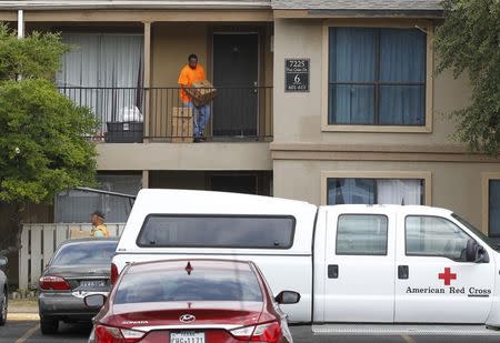 Workers from the Red Cross and the North Texas Food Bank deliver food to apartment unit at The Ivy Apartments where a man diagnosed with the Ebola virus was staying in Dallas, Texas October 2, 2014. REUTERS/Mike Stone