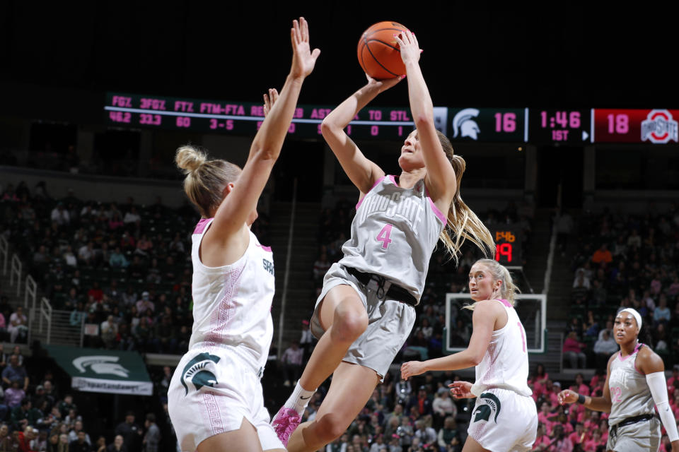 Ohio State guard Jacy Sheldon (4) shoots against Michigan State guard Theryn Hallock, left, during the first half of an NCAA college basketball game, Sunday, Feb. 11, 2024, in East Lansing, Mich. (AP Photo/Al Goldis)