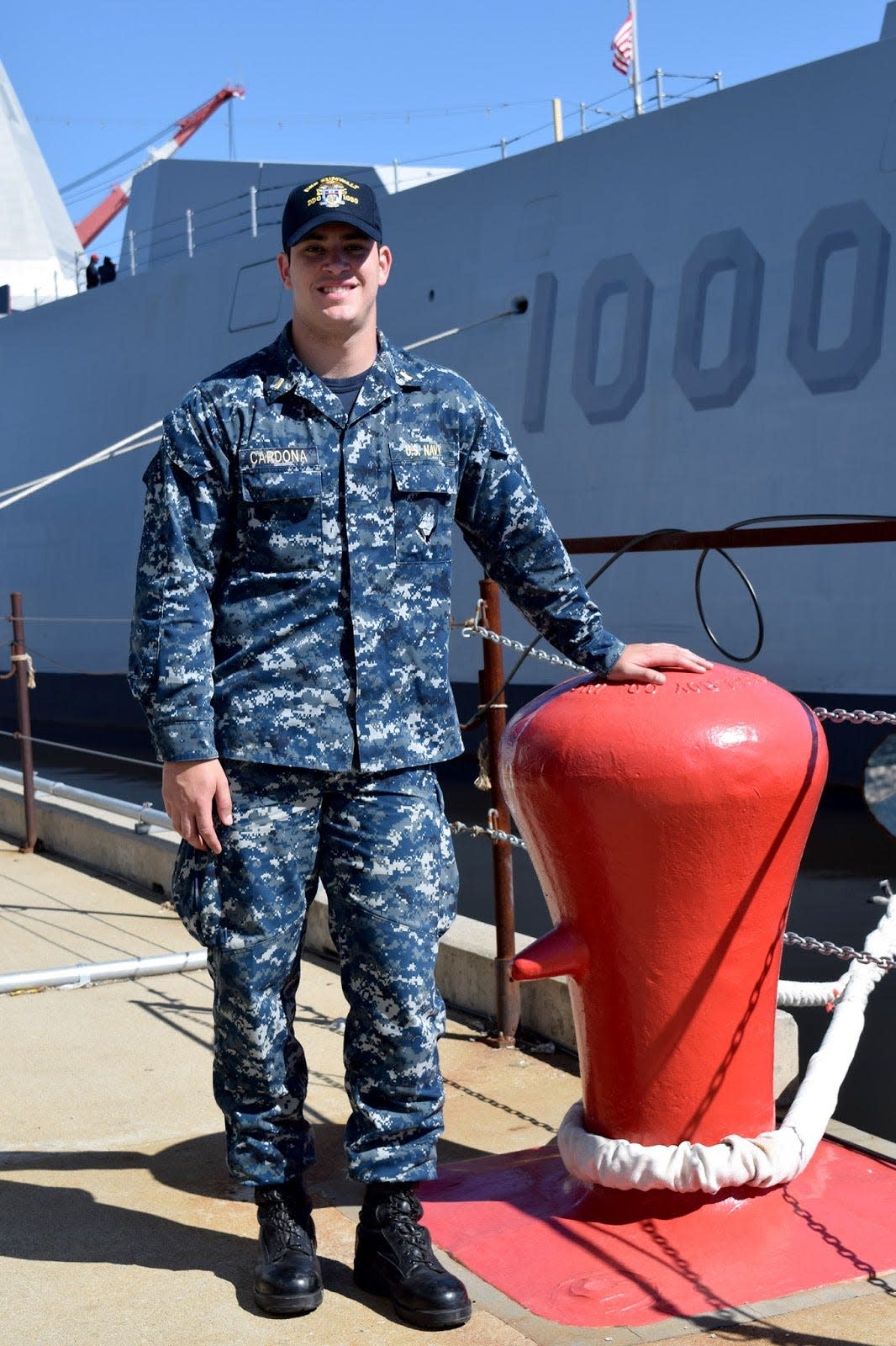 Then-Ensign Joe Cardona stands in front of his ship, the guided missile destroyer USS Zumwalt, under construction in 2016 in Bath, Maine. In addition to his active service in the Navy, Cardona is a long snapper for the New England Patriots.