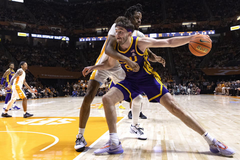 LSU forward Will Baker (9) works for a shot against Tennessee forward Jonas Aidoo during the second half of an NCAA college basketball game Wednesday, Feb. 7, 2024, in Knoxville, Tenn. (AP Photo/Wade Payne)