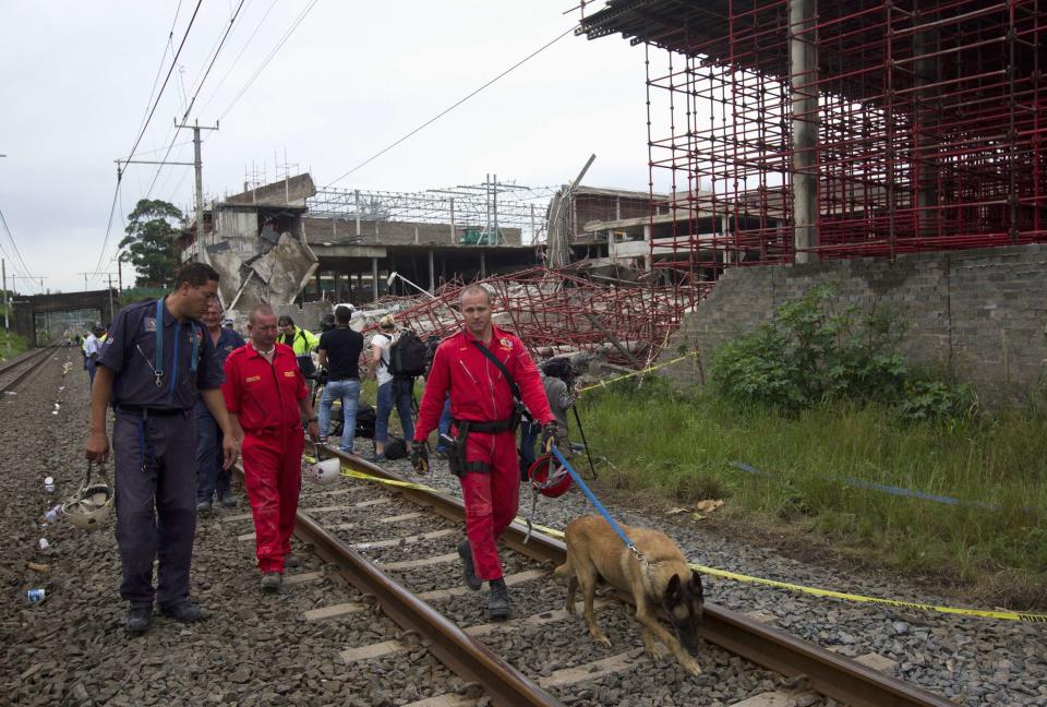 Emergency workers leave the scene as the search for survivors was called off after a three-storey building collapsed in the South African town of Tongaat, about 45 km (28 miles) north of Durban, November 20, 2013. Rescue workers with sniffer dogs picked through rubble in search of survivors on Wednesday after a soccer pitch-sized section of the half-built mall collapsed, killing at least one and injuring dozens. It was not immediately clear how many people might be still trapped in the wreckage after the three-storey building collapsed on Tuesday afternoon. Apart from one confirmed death, 29 people, two of them in critical condition, were rushed to nearby hospitals, which initiated full-scale disaster plans, health officials said. REUTERS/Rogan Ward (SOUTH AFRICA - Tags: DISASTER TPX IMAGES OF THE DAY)