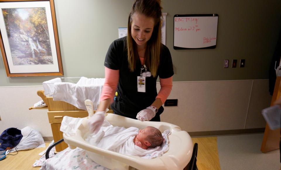 Registered Nurse Megan Weatherman bathes a newborn baby girl Amaris Trujillo at Littleton Adventist Hospital, part of Centura Health in Littleton, Colorado, U.S. May 3, 2016.  REUTERS/Rick Wilking 