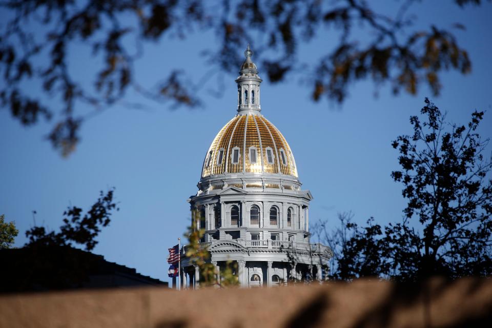 The gold-covered dome on the Colorado Capitol building shines in the late afternoon sun in downtown Denver in this Associated Press file photo.