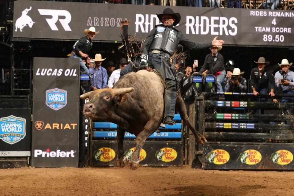 Eduardo Aparecido from the Arizona Ridge Riders, riding the bull "Chuck's Delight," competes at the Glendale PBR Teams event held at Desert Diamond Arena in Glendale, Ariz. on Sept. 30, 2023.