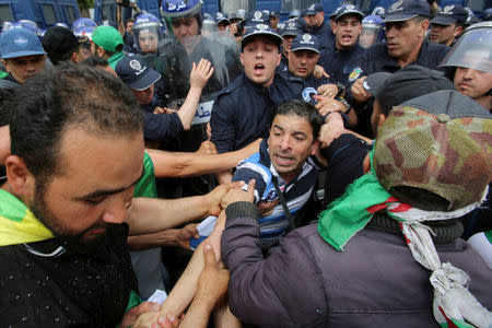 Demonstrators and police officers confront each other during a protest to demand the postponement of a presidential election and the removal of the ruling elite in Algiers, Algeria May 24, 2019. REUTERS/Ramzi Boudina