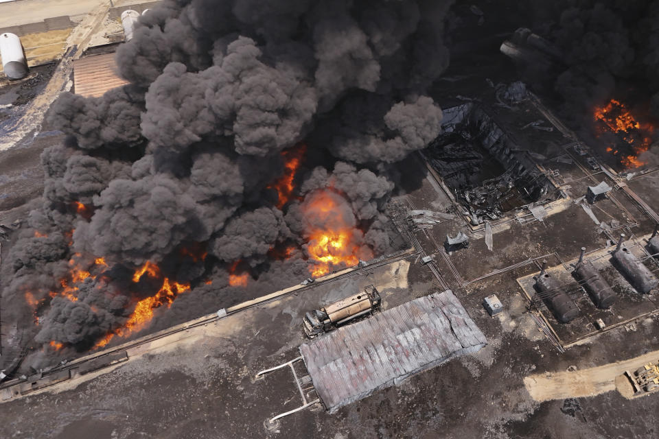 An oil refinery burns outside Irbil, Iraq, Thursday, June 13, 2024. (AP Photo/Bilind Tahir/Rudaw)