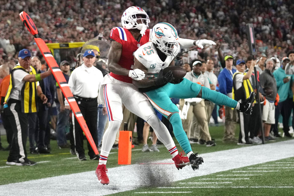 Miami Dolphins cornerback Xavien Howard (25) intercepts a pass intended for New England Patriots wide receiver DeVante Parker (1) during the second half of an NFL football game, Sunday, Sept. 17, 2023, in Foxborough, Mass. (AP Photo/Steven Senne)