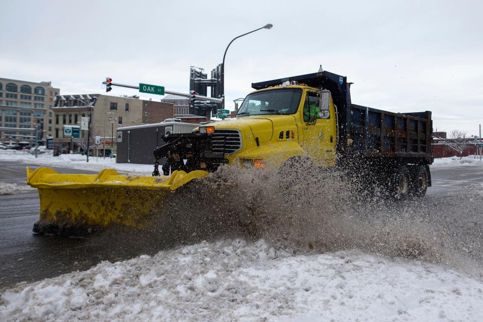 A snow plow clears snow from the road on Friday, Nov. 18, 2022, in Buffalo, New York.