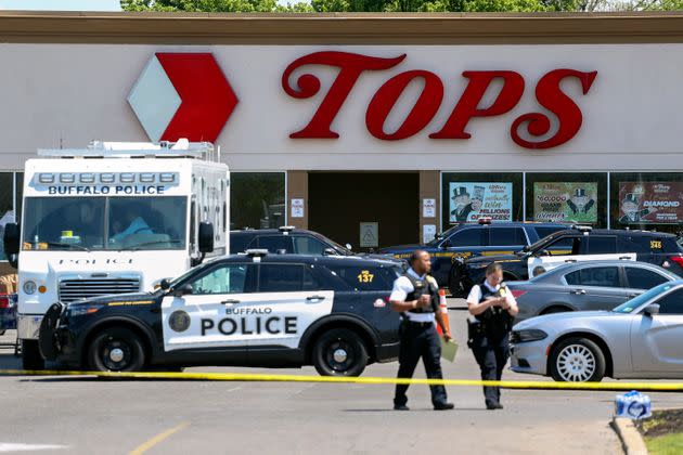 Police walk outside the Tops grocery store on May 15, 2022, in Buffalo, New York. 