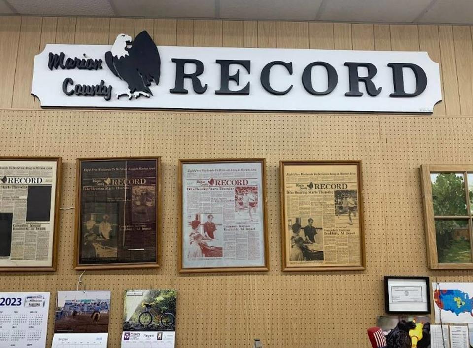 Front pages hang on a wall at the Marion County Record, where police served a search warrant Friday.