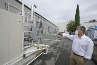 Micah Truman, CEO of Return Home, a company that composts human remains into soil, talks about the process that cleans and filters gasses emitted by his company's two-month composting process so that there are noticeable odors by the time the air is released to the environment, Wednesday, Sept. 15, 2021, in Auburn, Wash., south of Seattle. Earlier in September, Colorado became the second state after Washington to allow human body composting, and Oregon will allow the practice beginning next July. (AP Photo/Ted S. Warren)