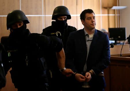 U.S. citizen Kevin Dahlgren, charged with the quadruple murder of his Czech relatives in 2013, leaves the courtroom after his trial at the Regional Court in Brno, Czech Republic, July 20, 2016. REUTERS/David W Cerny