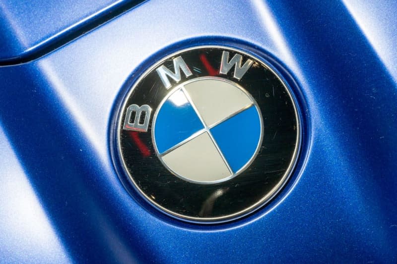 The BMW logo is displayed on the hood of one of the brand's vehicles at BMW Welt. Peter Kneffel/dpa