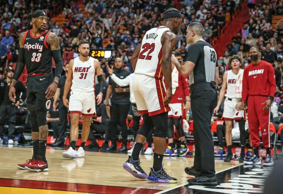 Miami Heat forward Jimmy Butler (22) talks with game official Mousa Dagher #28 before getting ejected in the second quarter during the game against the Portland Trail Blazers at FTX Arena in Miami on Wednesday, January 19, 2022.