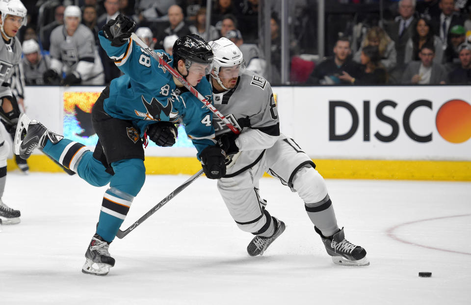 San Jose Sharks center Tomas Hertl, left, of the Czech Republic, battles with Los Angeles Kings defenseman Drew Doughty during the first period of an NHL hockey game, Saturday, April 11, 2015, in Los Angeles. (AP Photo/Mark J. Terrill)