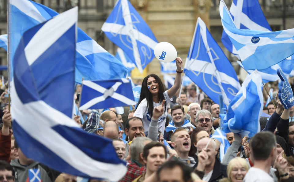 Campaigners wave Scottish Saltires at a 'Yes' campaign rally in Glasgow, Scotland in 2014 during first Scottish referendum. Photo: Dylan Martinez/Reuters