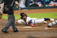 Atlanta Braves' Ronald Acuna Jr. scores on a double by Marcell Ozuna during the third inning in Game 1 of a baseball National League Division Series against the Miami Marlins Tuesday, Oct. 6, 2020, in Houston. (AP Photo/Eric Gay)