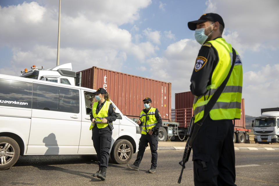 Israeli police check cars with Palestinian laborers as they search for two Palestinians who broke out of a maximum-security prison last week, on a road leading to the West Bank town of Jenin, near Gan Ner Israel, Sunday, Sept. 12, 2021. Israeli police on Saturday said they arrested four of the six Palestinians who broke out of the prison including Zakaria Zubeidi a famed militant leader whose exploits over the years have made him a well-known figure in Israel. (AP Photo/Ariel Schalit)