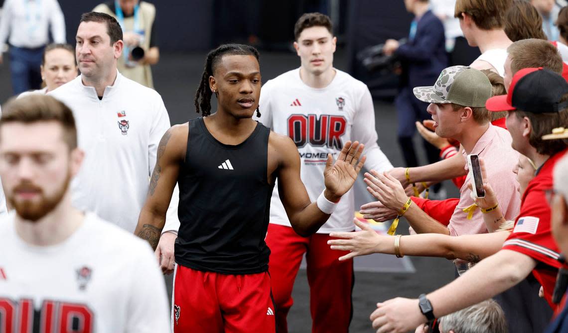 N.C. State’s DJ Horne and Michael O’Connell greet fans as they head to the court to warmup before N.C. State’s game against Purdue in the NCAA Tournament national semfinals at State Farm Stadium in Glendale, Ariz., Saturday, April 6, 2024. Ethan Hyman/ehyman@newsobserver.com