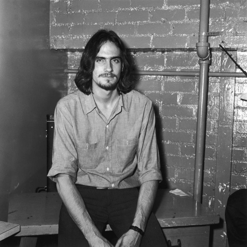 <p>Singer-songwriter James Taylor enjoys a few moments to himself before performing at The Troubadour nightclub in Los Angeles in 1970. </p>
