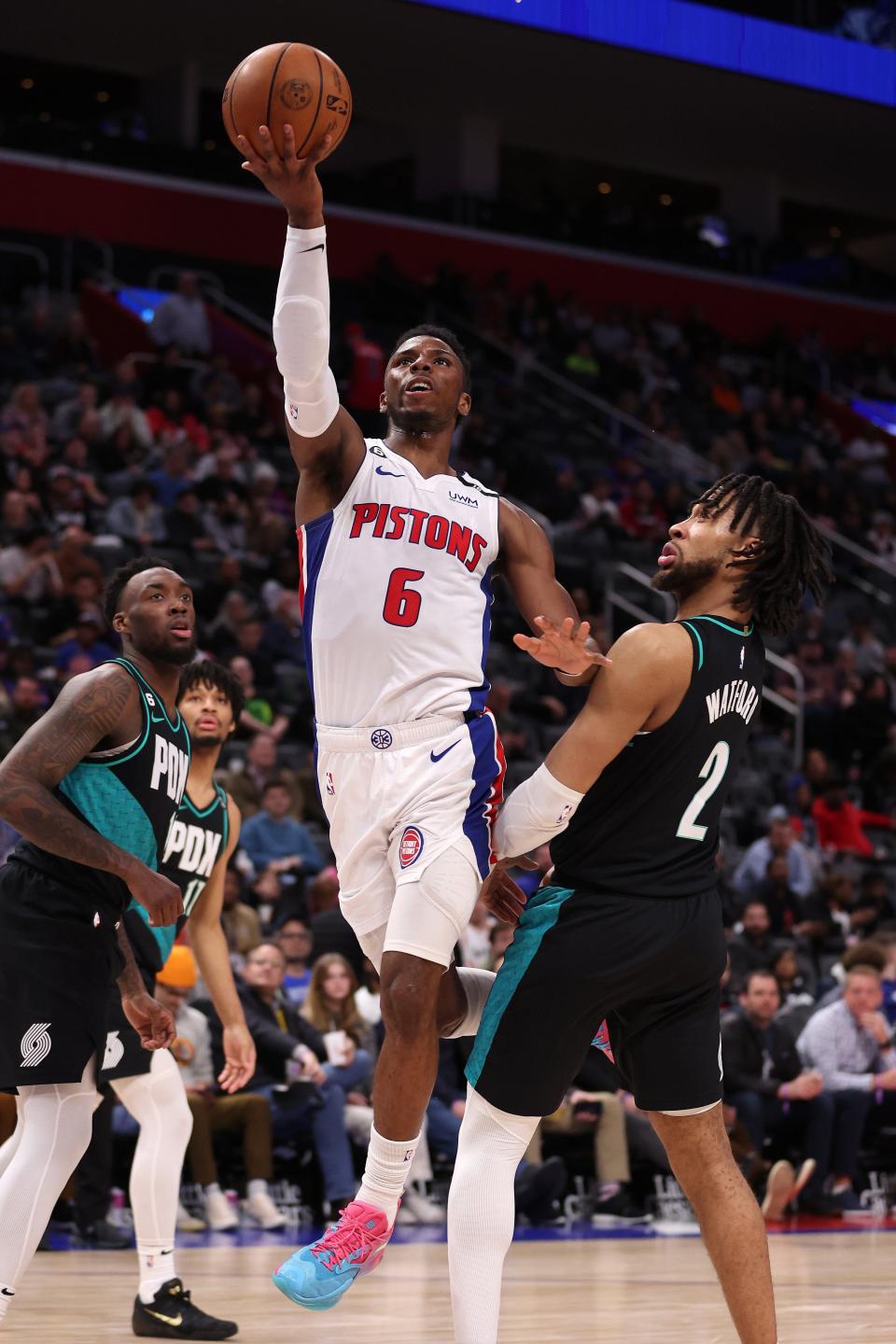 Pistons guard Hamidou Diallo drives to the basket past the Trail Blazers' Trendon Watford during the second half of the Pistons' 110-104 loss on Monday, March 6, 2023, at Little Caesars Arena.