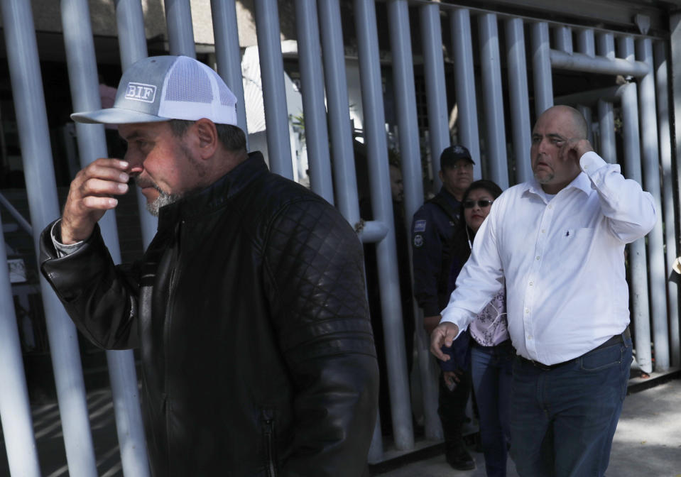 Adrian, left, and Julian LeBaron, who lost relatives and friends in a Nov. 4, 2019 ambush in northern Mexico, leave the office of the Special Prosecutor for Organized Crime Investigation, where they met with authorities in Mexico City, Tuesday, Jan. 7, 2020. Prosecutors said Tuesday more than 40 suspects have been identified in connection with the slaughter of the nine U.S. dual-national women and children. (AP Photo/Marco Ugarte)