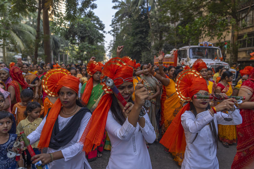 Hindu women dance to celebrate the upcoming opening of a grand temple for the Lord Ram, in India's northern Ayodhya city during a procession in Mumbai, India, Sunday, Jan. 21, 2024. (AP Photo/Rafiq Maqbool)