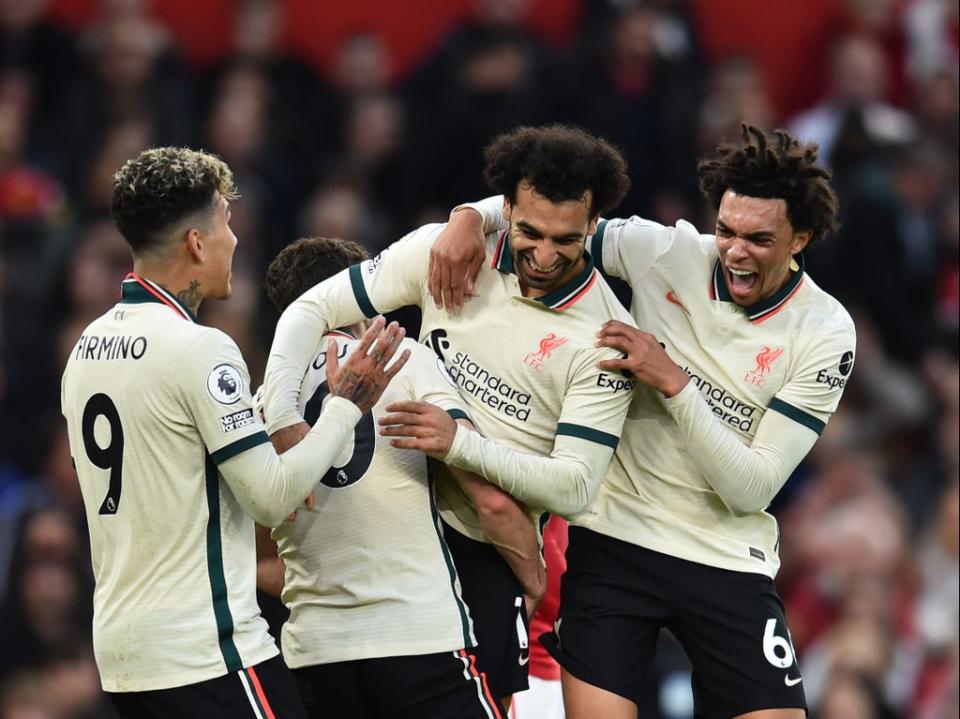 Mohamed Salah is mobbed by his Liverpool colleagues after completing his hat-trick (Liverpool FC/Getty)