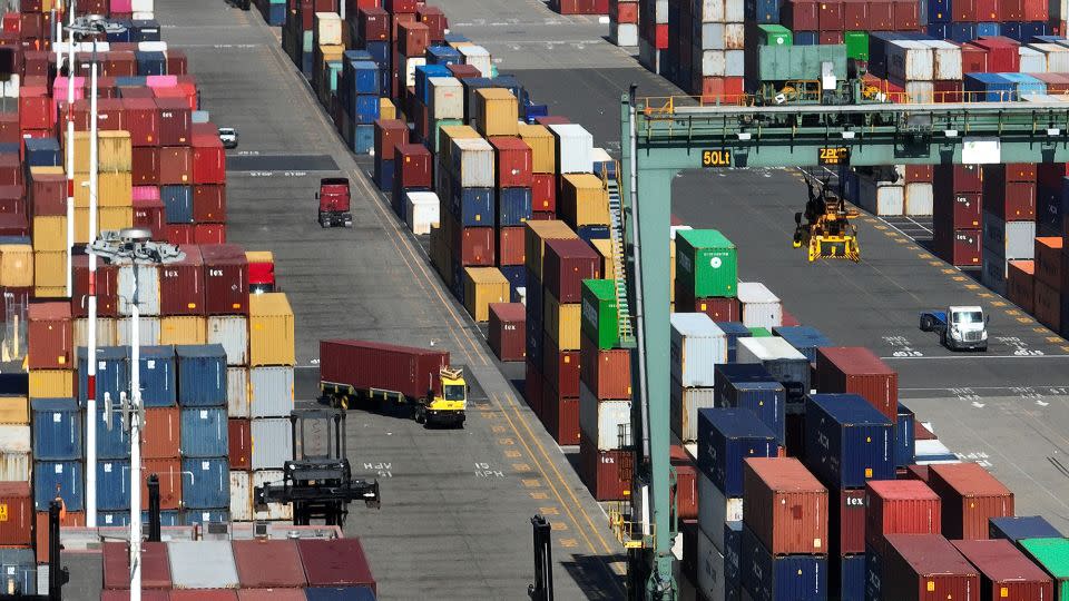 In an aerial view, shipping containers are seen stacked at the Port of Oakland on August 7, 2023, in Oakland, California. - Justin Sullivan/Getty Images