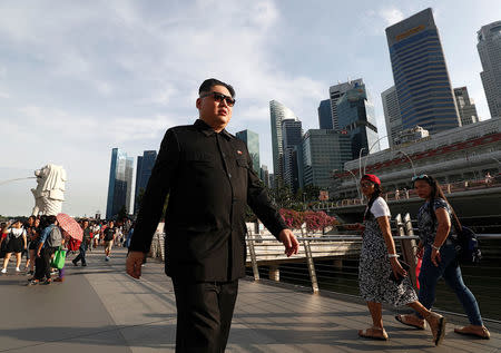 Howard, an Australian-Chinese impersonating North Korean leader Kim Jong Un, takes a stroll at Merlion Park in Singapore May 27, 2018. REUTERS/Edgar Su