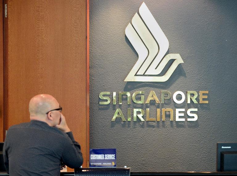A man waits at the customer service counter of Singapore Airlines at Changi International airport in Singapore on May 8, 2014