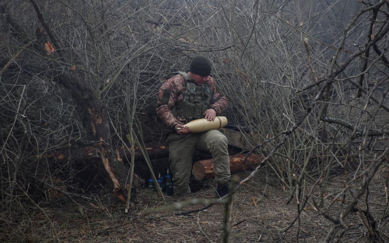 A Ukrainian serviceman of the 126th Separate Territorial Defence Brigade prepares a shell for a D-30 howitzer