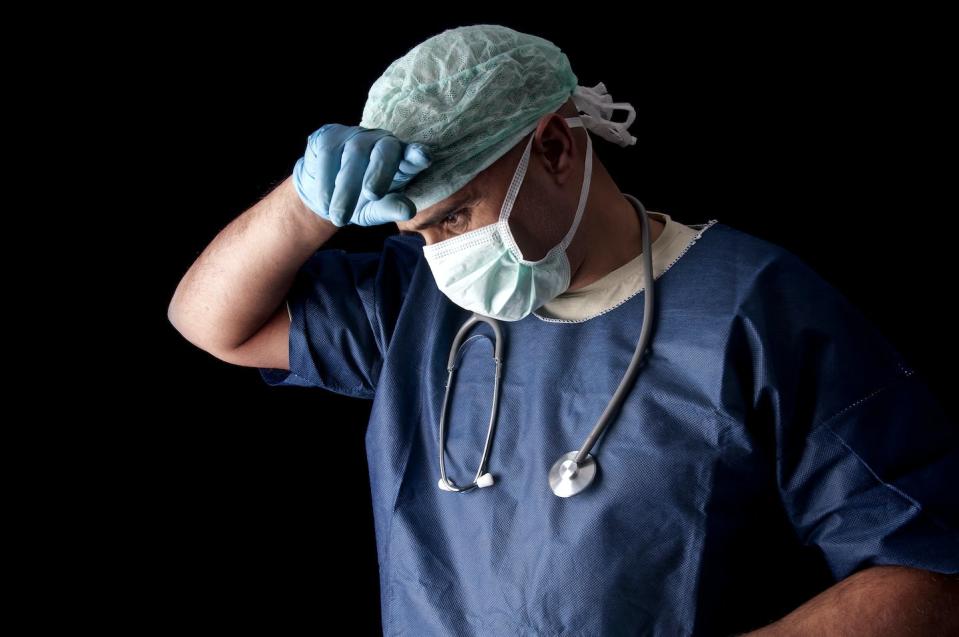 A large proportion of health-care workers are considering quitting. <a href="https://image.shutterstock.com/image-photo/tired-doctor-mask-dark-background-600w-96933794.jpg" rel="nofollow noopener" target="_blank" data-ylk="slk:Shutterstock" class="link ">Shutterstock</a>