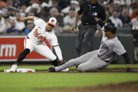 New York Yankees' Juan Soto. right, is tagged out by Baltimore Orioles third baseman Ramon Urias, left, trying to steal third base during the sixth inning of a baseball game, Wednesday, May 1, 2024, in Baltimore. (AP Photo/Nick Wass)