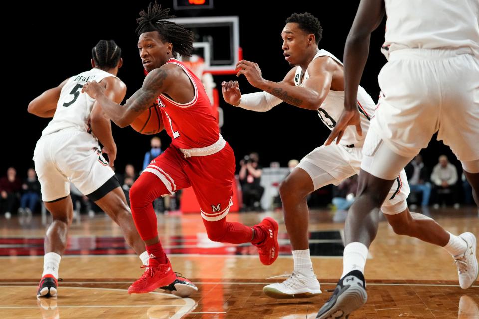 Miami RedHawks guard Mekhi Lairy drives to the basket as Cincinnati Bearcats guard Mika Adams-Woods (23) defends in the first half on Dec. 1, 2021, at Millett Hall in Oxford.