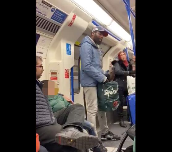 A screengrab of a viral Twitter video shows a Jewish father and son (left) who were reportedly targeted in an anti-Semitic rant by a man quoting Bible passages (center) on a London subway car on Friday. (Photo: @scatatkins)