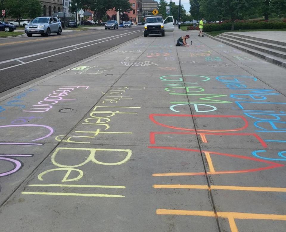 Idaho Abortion Rights members wrote in chalk outside the Idaho Capitol in Boise on Tuesday prior to demonstrations there.