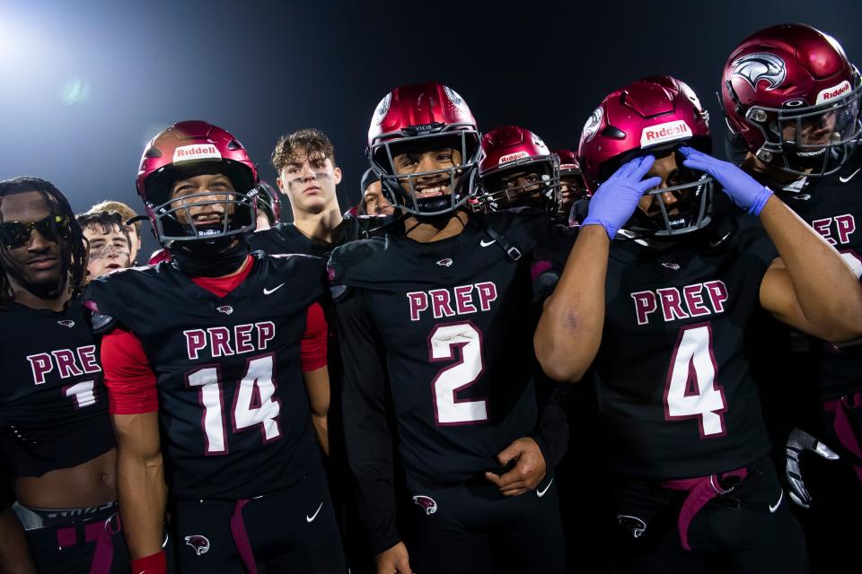St. Joseph's Prep seniors, including Samaj Jones (2), step forward to receive their trophy after winning the PIAA Class 6A football championship game against North Allegheny at Cumberland Valley High School, Saturday, Dec. 9, 2023, in Mechanicsburg, Pa. The Hawks won, 45-23.