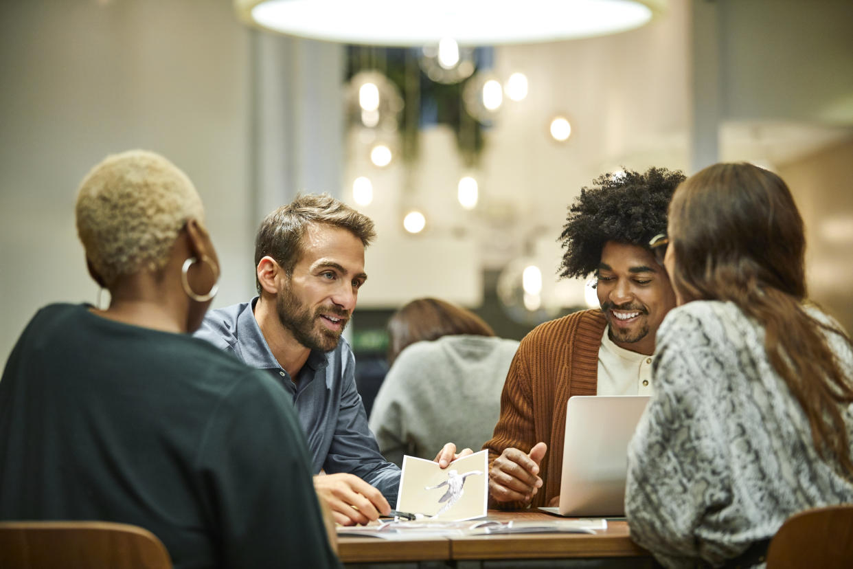 Business professionals discussing sex at desk. Male and female coworkers are working in office. They are in meeting. (Getty Images)