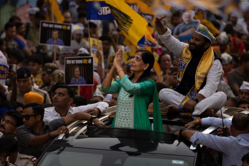 Sunita Kejriwal, wife of the jailed Aam Admi Party leader and Delhi Chief Minister Arvind Kejriwal, greets her supporters (AP)