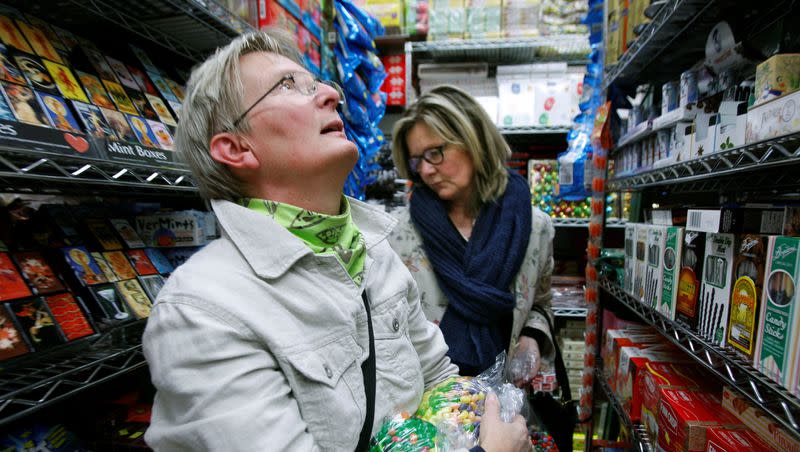 Marianne Skoglund of Orebro, Sweden, coddles an armload of jelly beans while shopping with a friend at Economy Candy on the Lower East Side in New York, Tuesday, Oct. 7, 2008.