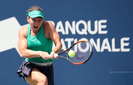 Aug 9, 2018; Montreal, Quebec, Canada; Simona Halep of Romania hits a shot against Anastasia Pavlyuchenkova of Russia (not pictured) during the Rogers Cup tennis tournament at Stade IGA. Mandatory Credit: Jean-Yves Ahern-USA TODAY Sports