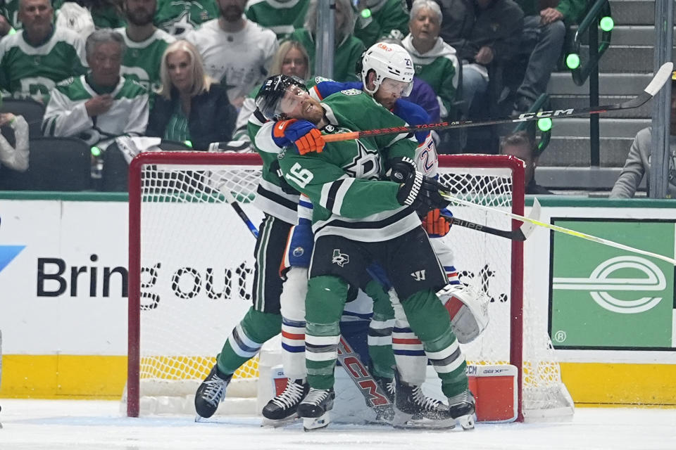 Dallas Stars center Joe Pavelski (16) and Edmonton Oilers defenseman Brett Kulak (27) tangle in front of the Oilers net during the second period of Game 5 of the Western Conference finals in the NHL hockey Stanley Cup playoffs Friday, May 31, 2024, in Dallas. (AP Photo/Julio Cortez)