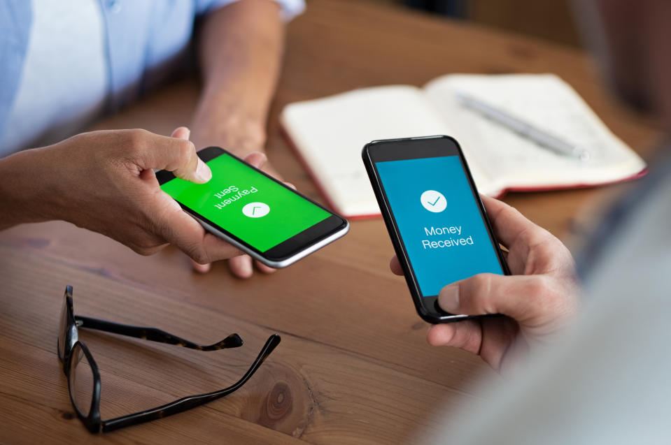 Two people transferring funds via their mobile phones.