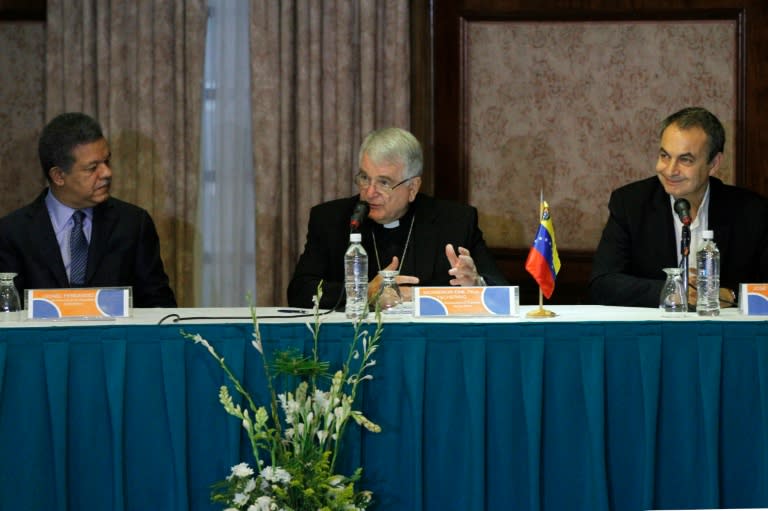 Former president of the Spanish government Jose Luis Rodriguez Zapatero (R) and Dominican Republic's former president Leonel Fernandez (L) meet Vatican representative Monsignor Emir Paul Tscherrig (C) in Caracas