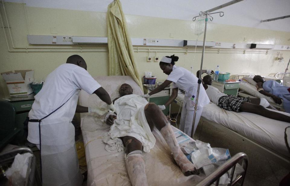 Paramedics treat a victim of Monday's explosion at Asokoro hospital in Abuja, Nigeria, Tuesday, April 15, 2014, with dozens feared dead as the blast destroyed more than 30 vehicles and caused secondary explosions as their fuel tanks exploded and burned. The Monday attack just miles from Nigeria's seat of government increases doubts about the military's ability to contain an Islamic uprising that is dividing the country on religious lines as never before. (AP Photo/ Sunday Alamba)