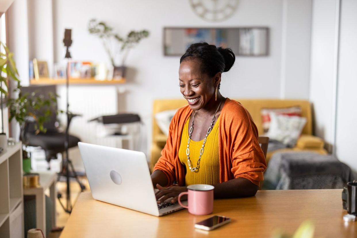 Mature woman working on laptop at home