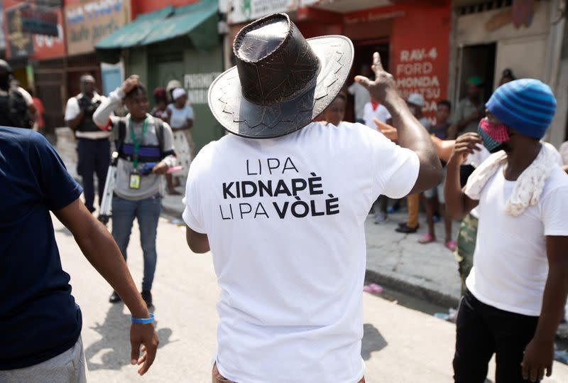 FILE PHOTO: A man wears a shirt reading "he is not a kidnapper, he is not a thief" in protest of an arrest made last week in Port-au-Prince