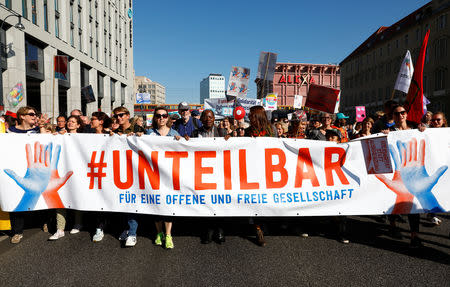 Protesters gather to the "#unteilbar", demonstration which aims to "rise up against discrimination, poverty, racism, sexism, disenfranchisement, and nationalism" in Berlin, Germany, October 13, 2018. REUTERS/Michele Tantussi