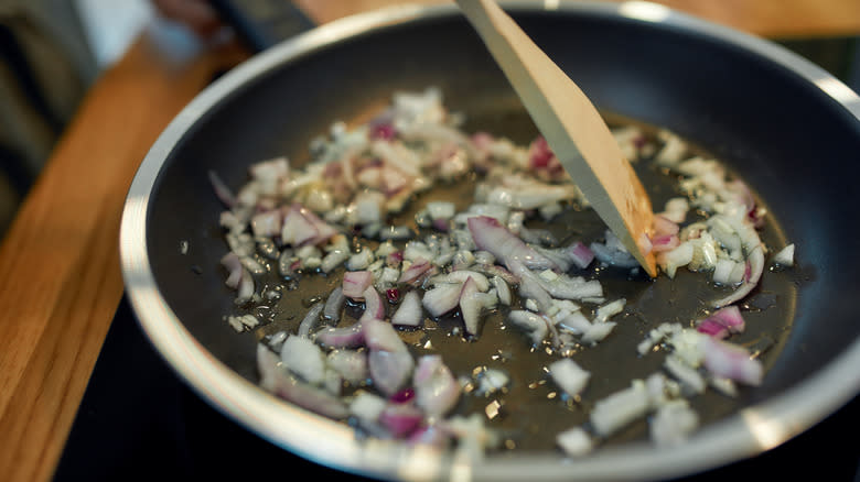onions sautéing in pan